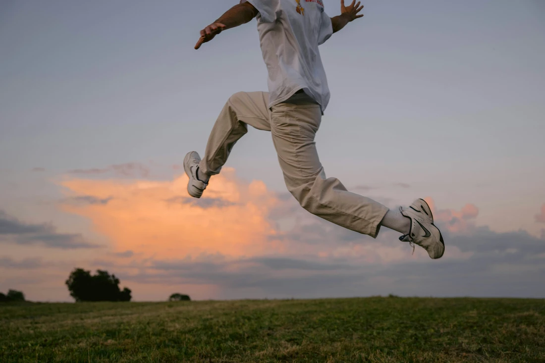 man jumping in a field